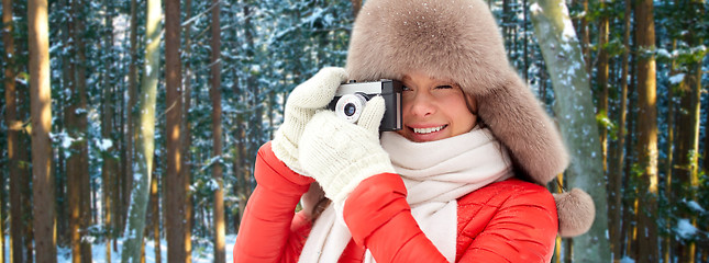 Image showing happy woman with film camera over winter forest