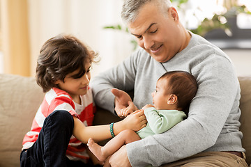 Image showing happy father with preteen and baby son at home