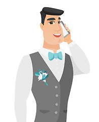 Image showing Young caucasian groom talking on a mobile phone.