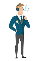 Image showing Groom listening to music in headphones.