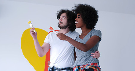 Image showing couple with painted heart on wall