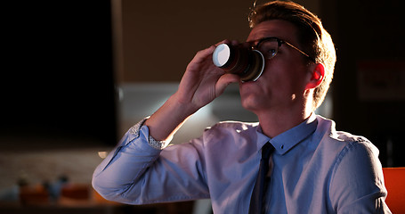 Image showing Tired businessman working late