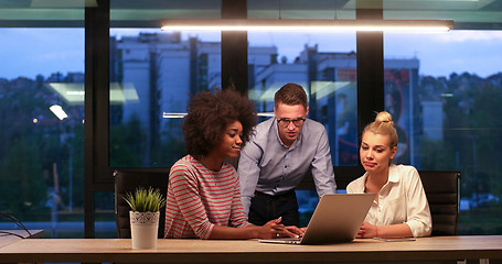 Image showing Multiethnic startup business team in night office