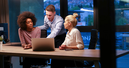 Image showing Multiethnic startup business team in night office