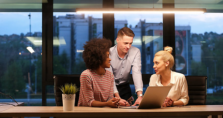 Image showing Multiethnic startup business team in night office