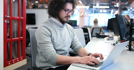 Image showing businessman working using a laptop in startup office