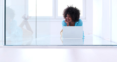 Image showing black women using laptop computer on the floor