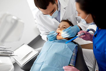 Image showing dentist checking for kid teeth at dental clinic