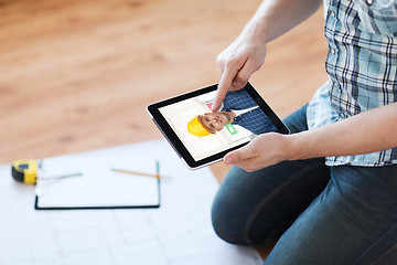 Image showing man having video call with builder on tablet pc