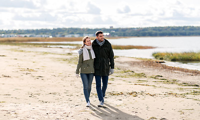 Image showing couple walking along autumn beach