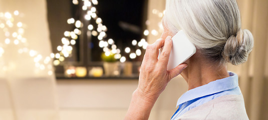 Image showing close up of senior woman calling on smartphone