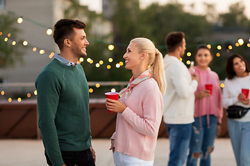 Image showing friends with drinks in party cups at rooftop