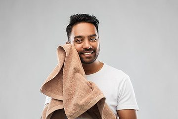 Image showing smiling indian man with towel over grey background