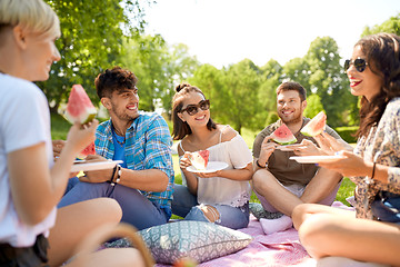 Image showing happy friends eating watermelon at summer picnic