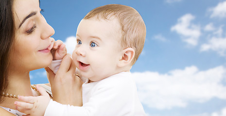 Image showing mother with baby over sky background