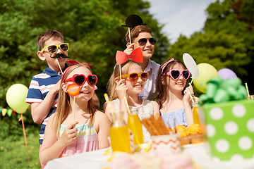 Image showing happy kids with party props on birthday in summer