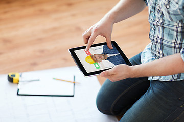 Image showing man having video call with builder on tablet pc