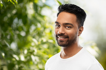 Image showing smiling indian man over green natural background