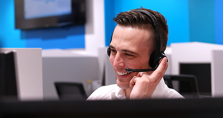 Image showing male call centre operator doing his job