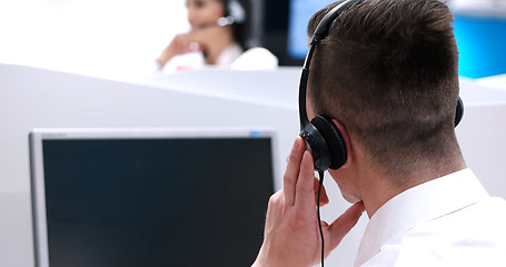 Image showing male call centre operator doing his job