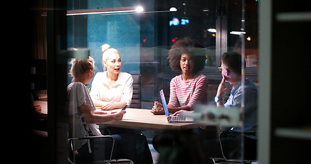 Image showing Multiethnic startup business team in night office