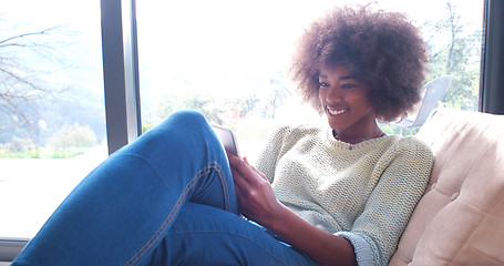 Image showing african american woman at home using digital tablet