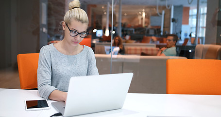 Image showing businesswoman using a laptop in startup office