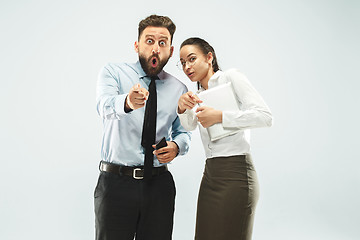 Image showing a business man shows the laptop to his colleague in the office.