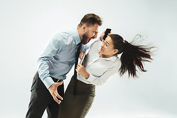 Image showing angry businessman and his colleague in the office.