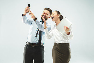 Image showing a business man shows the laptop to his colleague in the office.