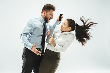 Image showing angry businessman and his colleague in the office.