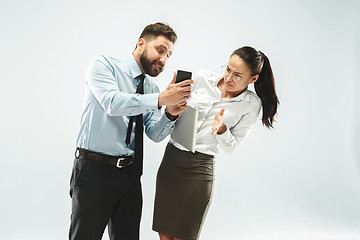 Image showing angry businessman and his colleague in the office.