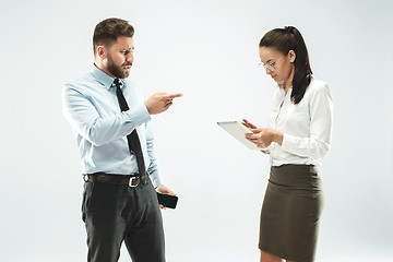 Image showing a business man shows the laptop to his colleague in the office.