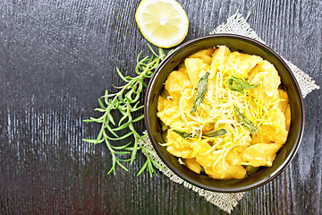 Image showing Gnocchi pumpkin with lemon in bowl on dark board top