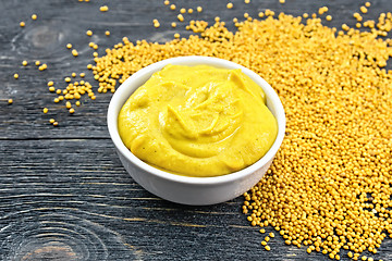 Image showing Sauce mustard in bowl with seeds on board