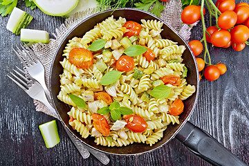 Image showing Fusilli with chicken and tomatoes in pan on board top