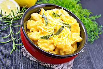 Image showing Gnocchi pumpkin with lemon in bowl on dark board