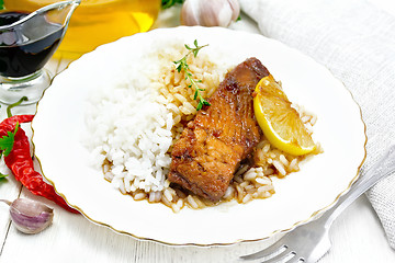 Image showing Salmon with sauce and rice in plate on white board