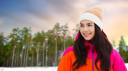 Image showing happy teenage girl in winter clothes outdoors