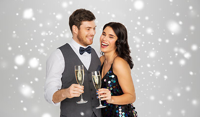 Image showing happy couple with champagne celebrating christmas