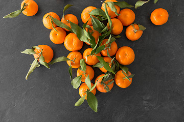 Image showing close up of mandarins on slate table top