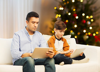 Image showing father and son with tablet computers on christmas