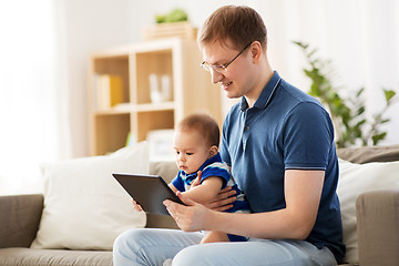 Image showing happy father and baby son with tablet pc at home