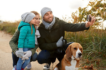 Image showing happy family with dog taking selfie in autumn