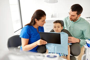 Image showing dentist showing tablet pc to kid at dental clinic