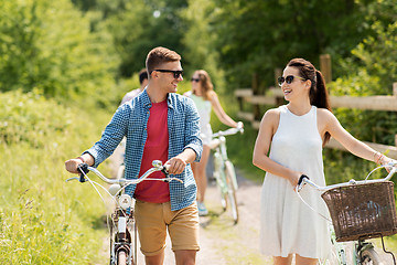 Image showing happy couple with fixed gear bicycles in summer