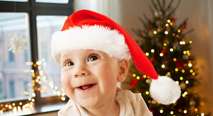 Image showing happy little baby boy in santa hat on christmas