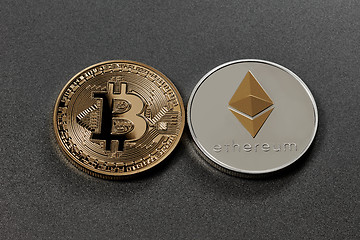 Image showing Gold and silver coins of crypto-currency on a dark background. Business concept