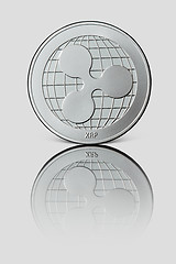 Image showing Silver coin ripple on white glossy background.