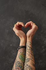 Image showing Female hands with tattoos in shape of heart